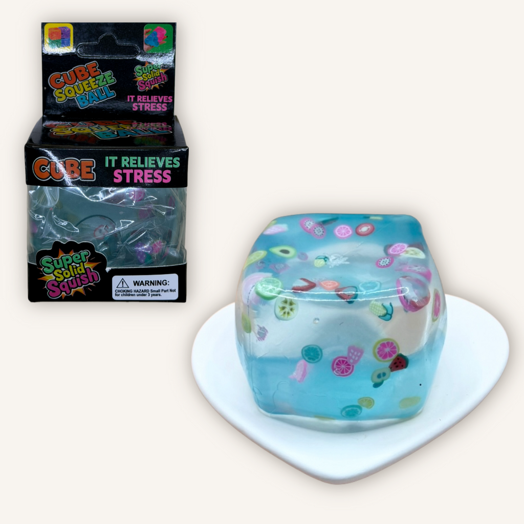 Fruit filled squishy cube sensory toy shown with packaging, featuring colourful fruit pieces inside a soft translucent gel cube.