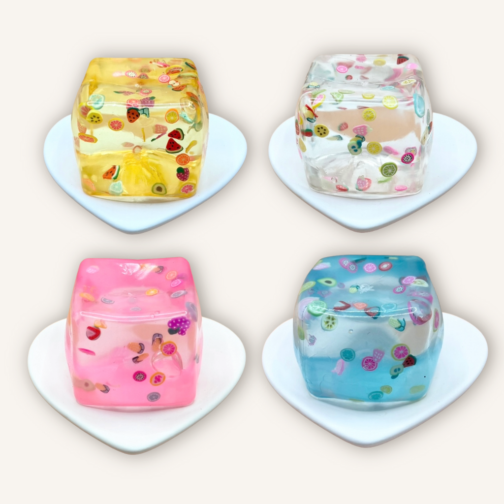 Fruit filled squishy cubes in assorted colours with colourful fruit pieces, soft gel texture, and satisfying sensory squeeze.