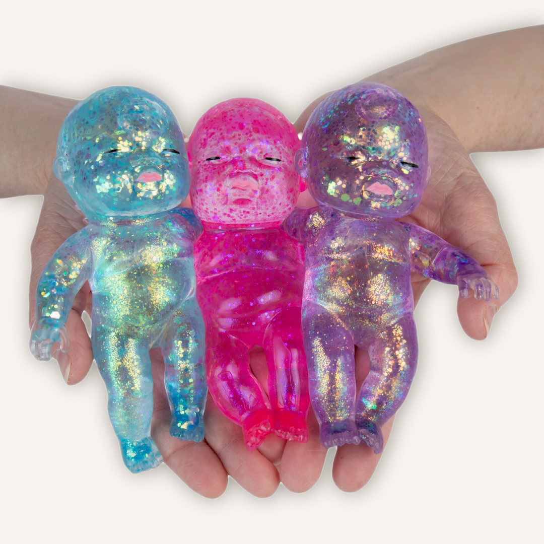 ORB Sugar Swaps Onesies collectible sensory squishies shown in multiple colourful character styles with glitter-filled tactile texture.